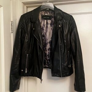 Black rivet faux leather jacket.